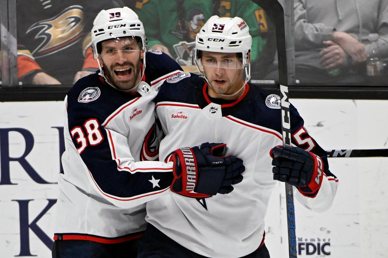 Columbus Blue Jackets center Boone Jenner (38) celebrates a goal by right wing Yegor Chinakhov (59) against the Anaheim Ducks during the third period of an NHL hockey game in Anaheim, Calif., Wednesday, Feb. 21, 2024. (AP Photo/Alex Gallardo)