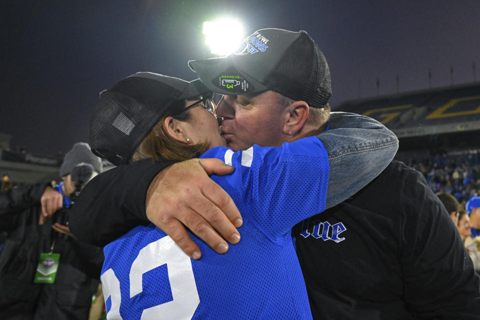 Duke head coach Mike Elko kisses his wife after defeating UCF in the Military Bowl NCAA college football game, Wednesday, Dec. 28, 2022, in Annapolis, Md. (AP Photo/Terrance Williams)