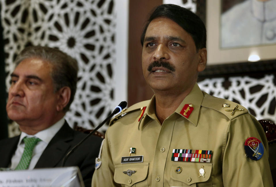 Pakistan's military spokesman Maj. Gen. Asif Ghafoor, right, speaks while Foreign Minister Shah Mahmood Qureshi looks on during a press conference in Islamabad, Pakistan, Saturday, Aug. 17, 2019. Ghafoor said the country's armed forces are fully prepared to respond to any Indian aggression. Pakistani Foreign Minister Shah Mahmood Qureshi also told reporters in the Pakistani capital that it was possible India could resort to a military misadventure on the disputed border to deviate world's attention from human right violations and the clampdown in occupied Kashmir. (AP Photo/Anjum Naveed)