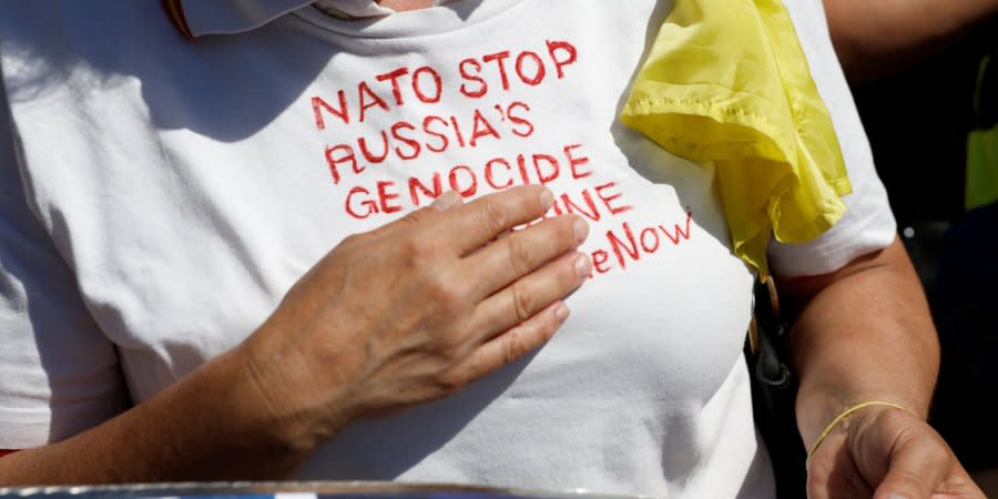 A call to NATO to stop Russia's genocide on T-shirt of Ukrainian protesters during NATO summit in Madrid, June 29