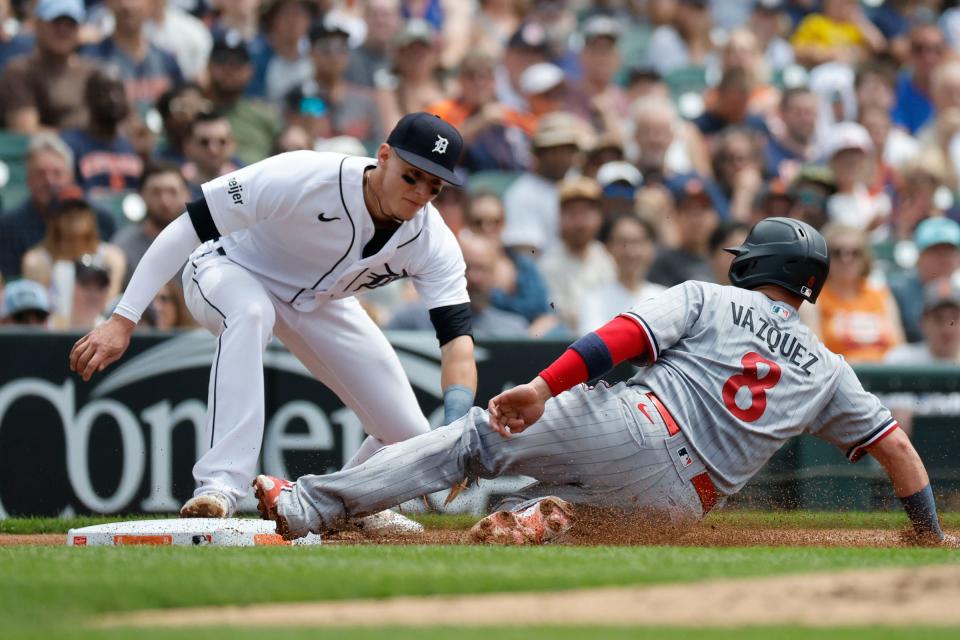 Minnesota Twins catcher Christian Vazquez (8) slides in safe at third in front of Detroit Tigers third baseman Nick Maton (9) after tagging up at Comerica Park in Detroit, Michigan on Jue 25, 2023.