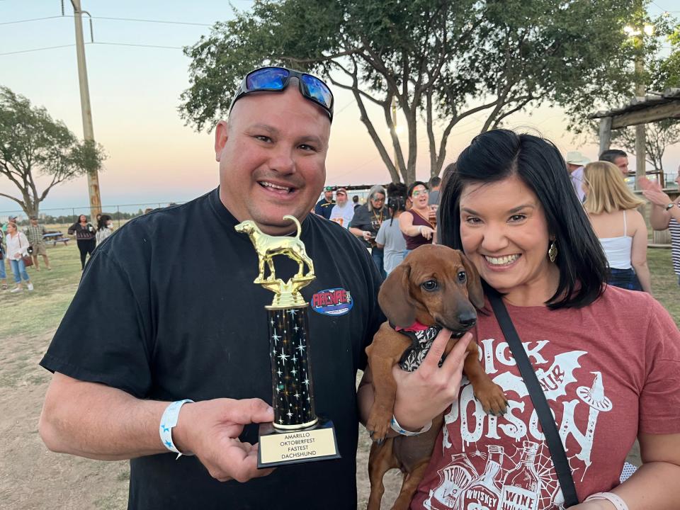 "Buns," accompanied by trainers Paul and Chrissy Deande will be returning to the Wiener Dog Races to defend Bun's title of being Top Wiener at the second Oktoberfest to be at 6 pm Saturday at Starlight Ranch.