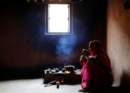 Kamal Keshavtupange, 60, who studies at Aajibaichi Shaala (Grandmothers' School), drinks tea inside her house in Fangane village, India, February 15, 2017. REUTERS/Danish Siddiqui