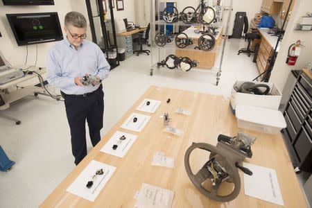 Consulting materials engineer Mark Hood shows the ignition assembly which has a faulty 2005 ignition switch (black piece at left), in the mechanical testing laboratory at McSwain Engineering, Inc. in Pensacola, Florida, March 28, 2014. REUTERS/Michael Spooneybarger