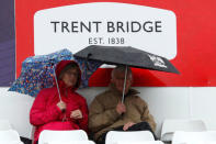 Cricket - England vs West Indies - Second One Day International - Trent Bridge, Nottingham, Britain - September 21, 2017 Fans shelter under their umbrellas as rain stops play Action Images via Reuters/Andrew Boyers