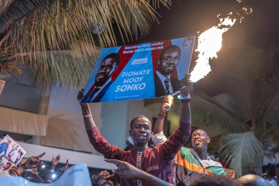 Supporters celebrate the release of Senegal's top opposition leader Ousmane Sonko and his key ally Bassirou Diomaye Faye outside Sonko's home in Dakar, Senegal, Thursday, March 14, 2024. Sonko had been in prison since July 2023 and has fought a prolonged legal battle to run for president in the March 24 election.(AP Photo/Sylvain Cherkaoui)