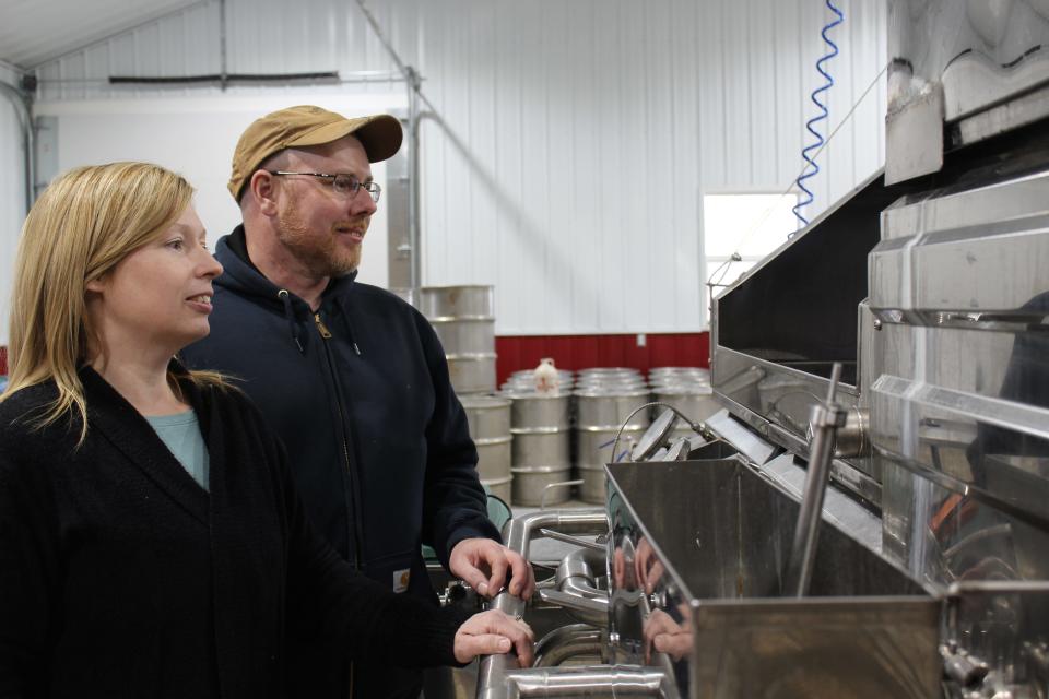 Jeremy and Ginny Walters, owners of Wagner's Sugar Camp near Salisbury, stand by the evaporator during one of the tours on Saturday during the 2023 Maple Taste and Tour.