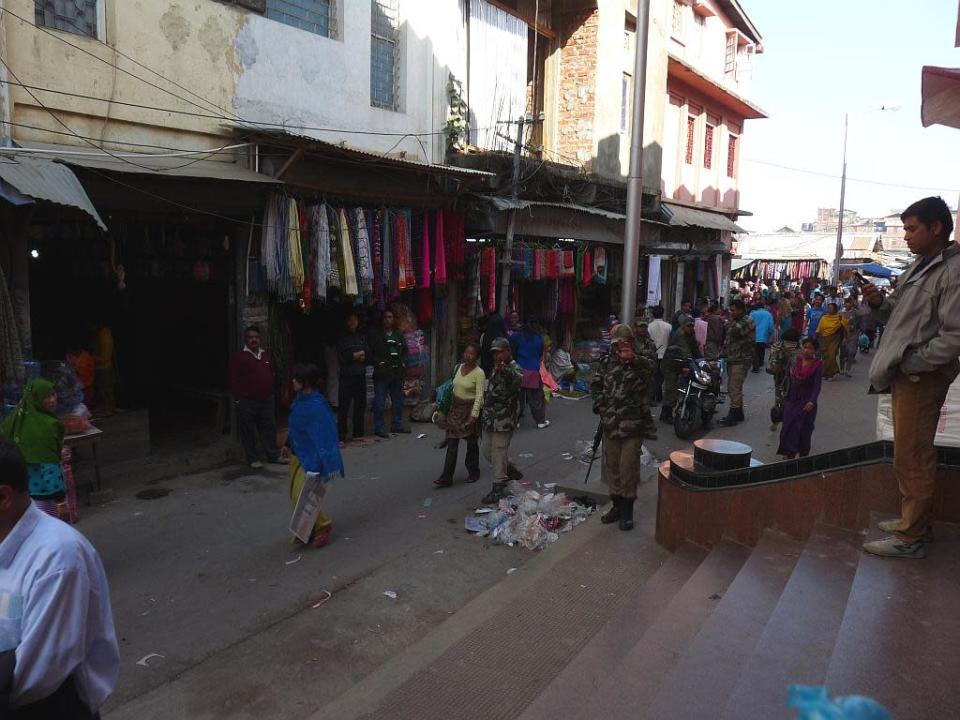 Armed soldiers patrolling the lanes outside Ima Market order me to stop photographing. Often, ethnic differences can come to a boil in these public spaces.