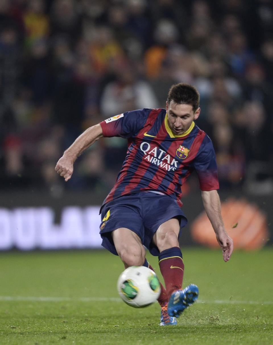 FC Barcelona's Lionel Messi, from Argentina, kicks the ball to score against Getafe during a Copa del Rey soccer match at the Camp Nou stadium in Barcelona, Spain, Wednesday, Jan. 8, 2014. (AP Photo/Manu Fernandez)