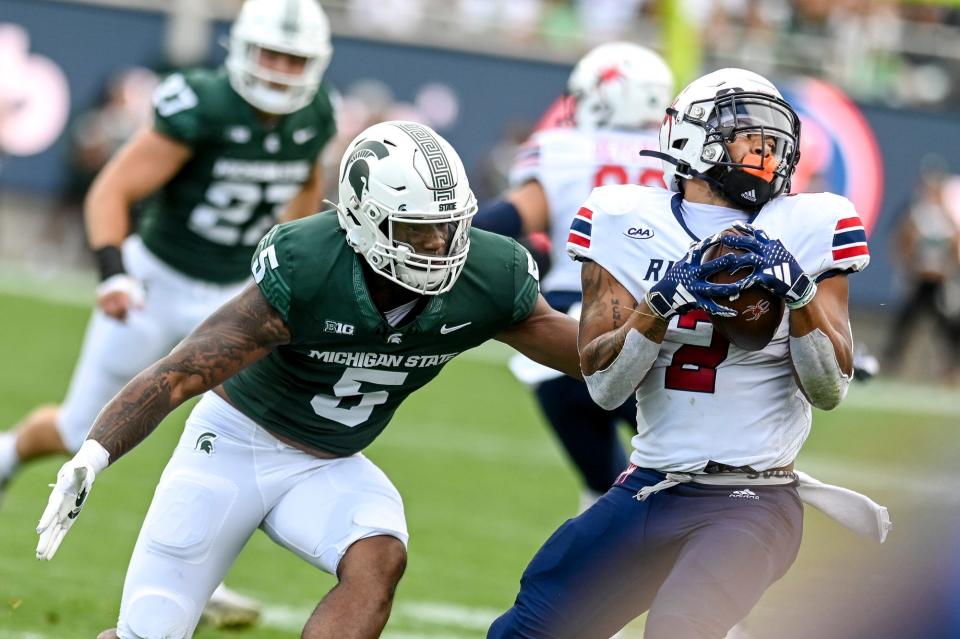 Michigan State's Jordan Hall, left, tackles Richmond's Savon Smith during the second quarter on Saturday, Sept. 9, 2023, at Spartan Stadium in East Lansing.