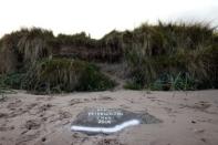 A stone marks the spot where Peter Wilson's remains were discovered in 2010 at Waterfoot beach in County Antrim November 5, 2014. REUTERS/Cathal McNaughton