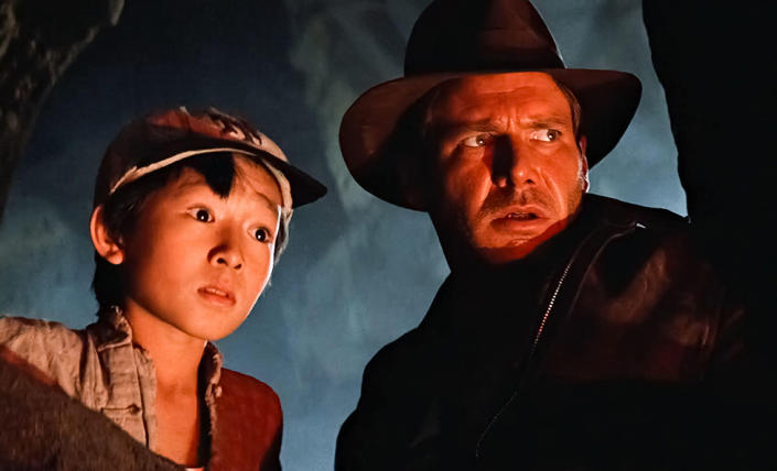 To Huy Quan and Harrison Ford in the film Indiana Jones and the Temple of Doom