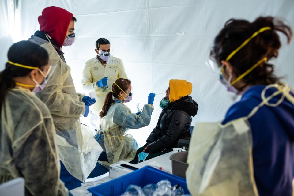 Doctors test hospital staff with flu-like symptoms for coronavirus in set-up tents to triage possible COVID-19 patients outside before they enter the main Emergency department area at St. Barnabas Hospital in the Bronx on March 24, 2020 in New York City.