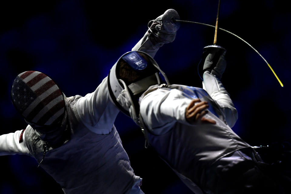 Tamas Meszaros, right, of Hungary and Race Imboden of United States fence during the men's team foil round of 16 match of the FIE World Fencing Championships in Budapest, Hungary, Monday, July 22, 2019. (Tibor Illyes/MTI via AP)