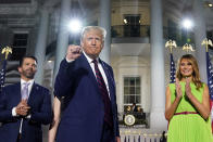 From left, Donald Trump Jr., President Donald Trump and first lady Melania Trump stand on the South Lawn of the White House on the fourth day of the Republican National Convention, Thursday, Aug. 27, 2020, in Washington. (AP Photo/Evan Vucci)