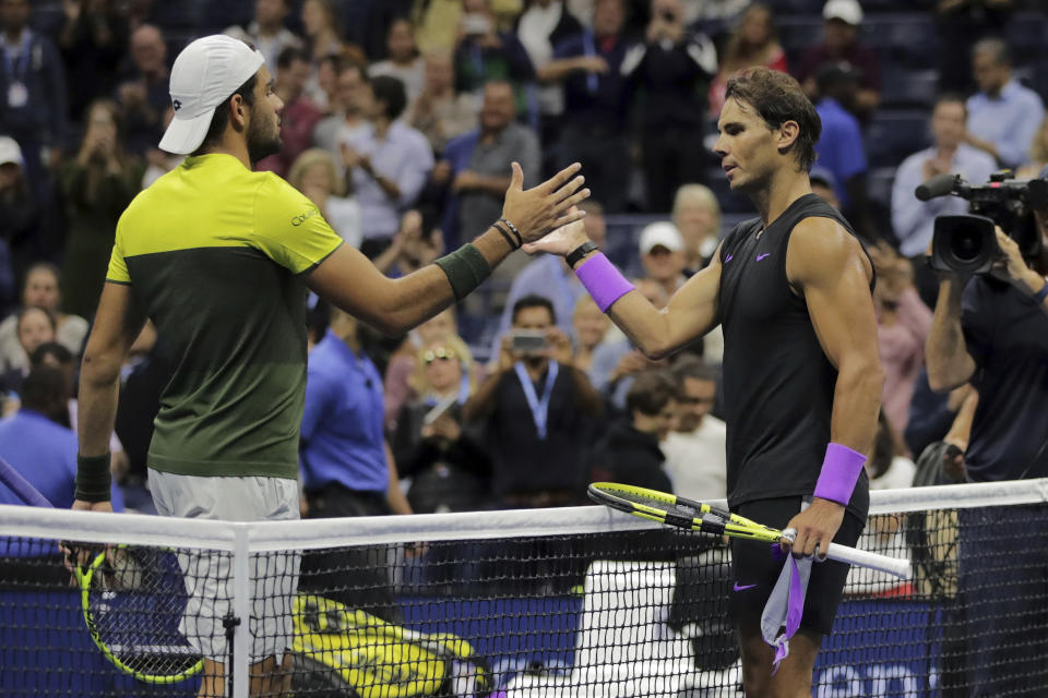 Matteo Berrettini, of Italy, left, congratulates Rafael Nadal, of Spain, after Nadal won their men's singles semifinal of the U.S. Open tennis championships Friday, Sept. 6, 2019, in New York. (AP Photo/Charles Krupa)