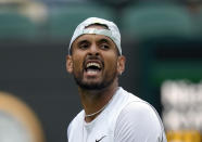 Australia's Nick Kyrgios celebrates a point against Greece's Stefanos Tsitsipas during a third round men's singles match on day six of the Wimbledon tennis championships in London, Saturday, July 2, 2022. (AP Photo/Kirsty Wigglesworth)