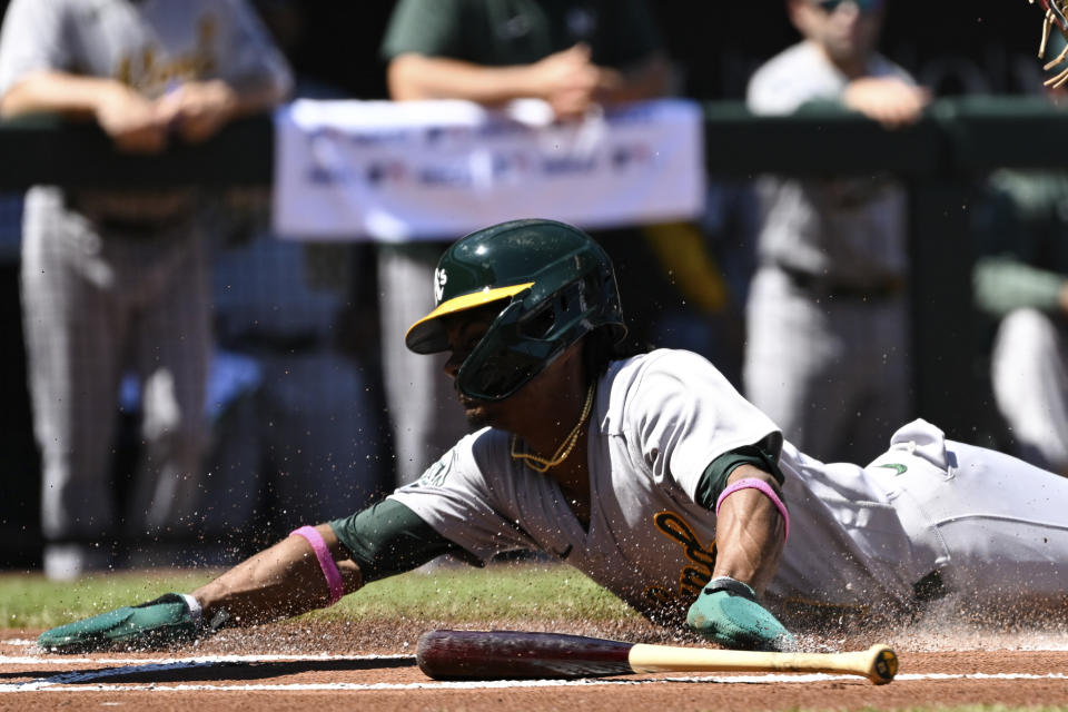 Oakland Athletics' Esteury Ruiz scores a run on a sacrifice fly hit by Brent Rooker against Baltimore Orioles starting pitcher Cole Irvin during the first inning of a baseball game, Thursday, April 13, 2023, in Baltimore. (AP Photo/Terrance Williams)