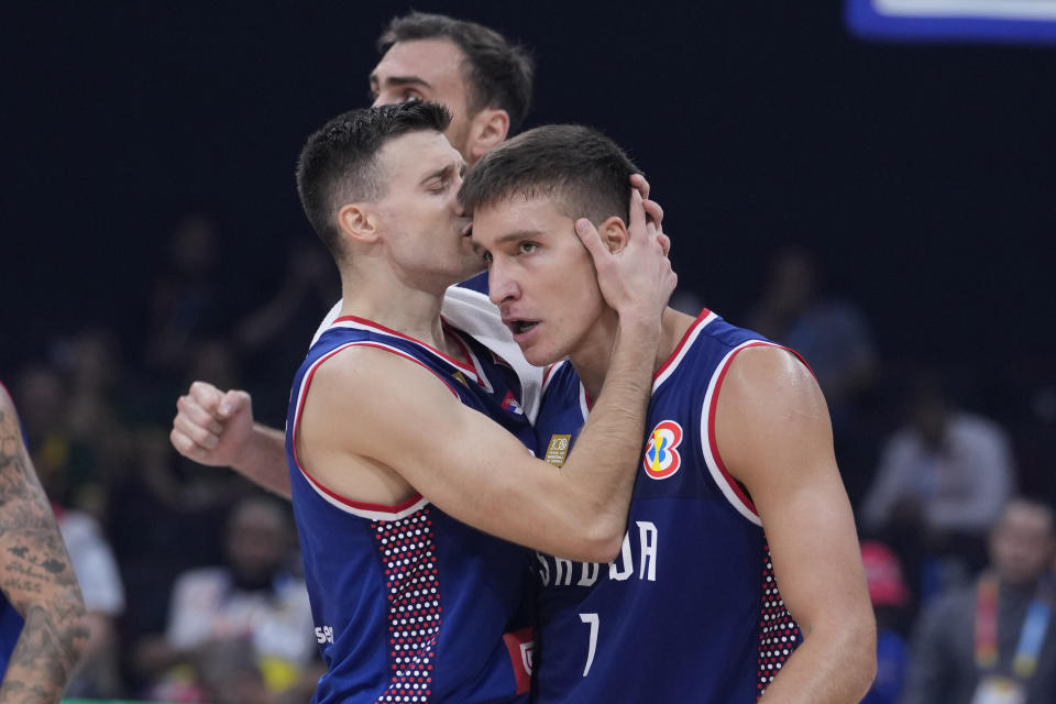 Serbia guard Aleksa Avramovic (30) and Serbia guard Bogdan Bogdanovic (7) celebrate during the Basketball World Cup quarterfinal game between Lithuania and Serbia at the Mall of Asia Arena in Manila, Philippines, Tuesday, Sept. 5, 2023. (AP Photo/Michael Conroy)