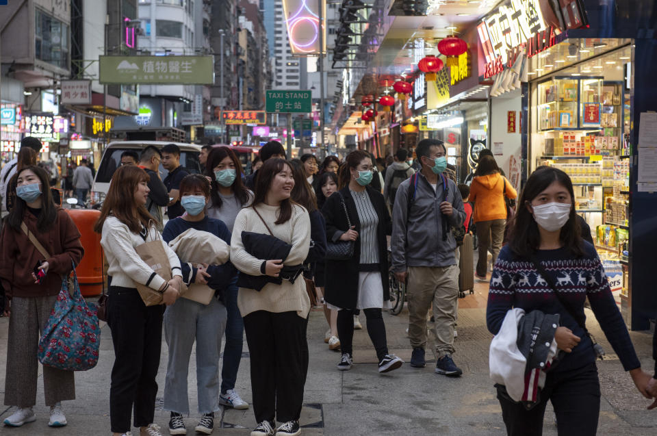 Pedestrians cover their faces with sanitary masks after the first cases of coronavirus have been confirmed in Hong Kong. Hours earlier, China officially announced the Wuhan's virus outbreak can be transmitted human-to-human. (Photo by Miguel Candela / SOPA Images/Sipa USA)