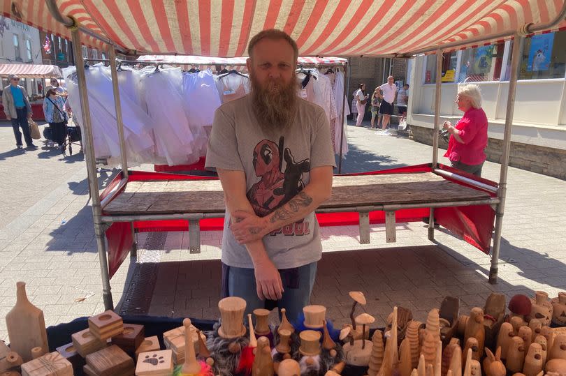 Martin Starkey at his market stand in Hucknall stood in front of his wooden goods