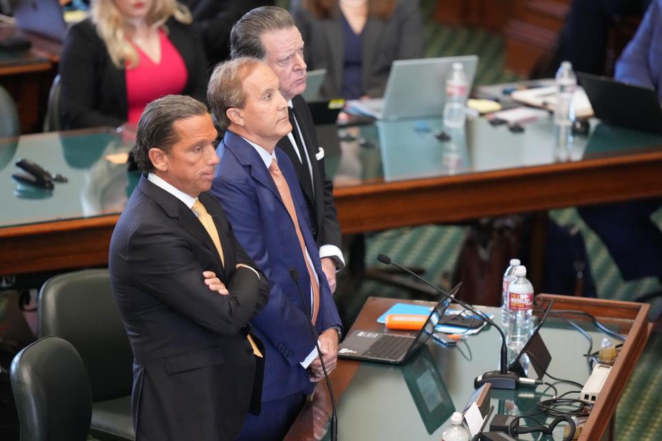 From left, lawyer Tony Buzbee, Ken Paxton and lawyer Dan Cogdell stand as Paxton pleads not guilty during his impeachment trial Tuesday, in the Senate chamber at the Capitol. The trial will determine if the suspended attorney general will be removed from office.