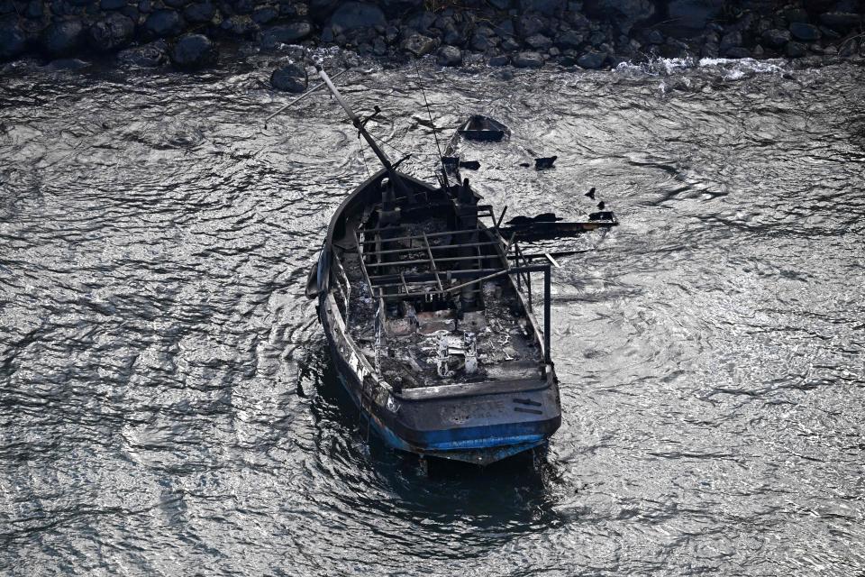 An aerial image taken on August 10, 2023 shows a burned boat in the Lahaina Harbor in the aftermath of wildfires in western Maui, Hawaii. At least 36 people have died after a fast-moving wildfire turned Lahaina to ashes, officials said August 9, 2023 as visitors asked to leave the island of Maui found themselves stranded at the airport. The fires began burning early August 8, scorching thousands of acres and putting homes, businesses and 35,000 lives at risk on Maui, the Hawaii Emergency Management Agency said in a statement. (Photo by Patrick T. Fallon / AFP) (Photo by PATRICK T. FALLON/AFP via Getty Images)