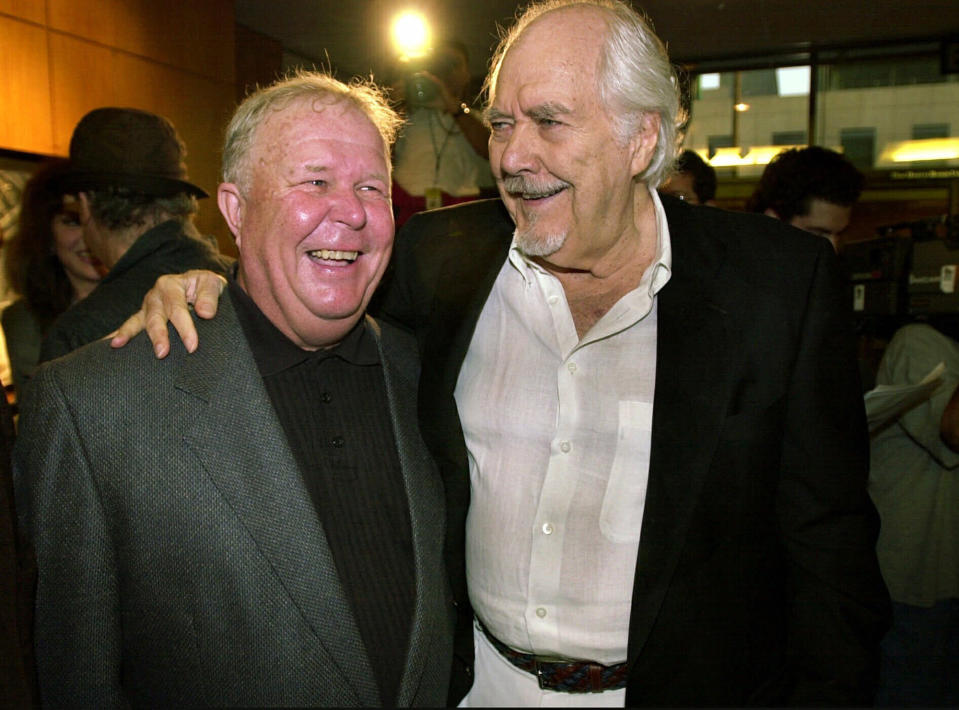 FILE - In this Thursday, June 22, 2000, file photo, director-producer Robert Altman, right, laughs with actor Ned Beatty prior to the 25th anniversary screening of "Nashville," at the Academy of Motion Picture Arts and Sciences in Beverly Hills, Calif. Beatty portrayed Delbert Reese in Altman's film. Beatty, the indelible character actor whose first film role, as a genial vacationer raped by a backwoodsman in 1972′s “Deliverance,” launched him on a long, prolific and accomplished career, died Sunday, June 13, 2021. He was 83. (AP Photo/Michael Caulfield, File)