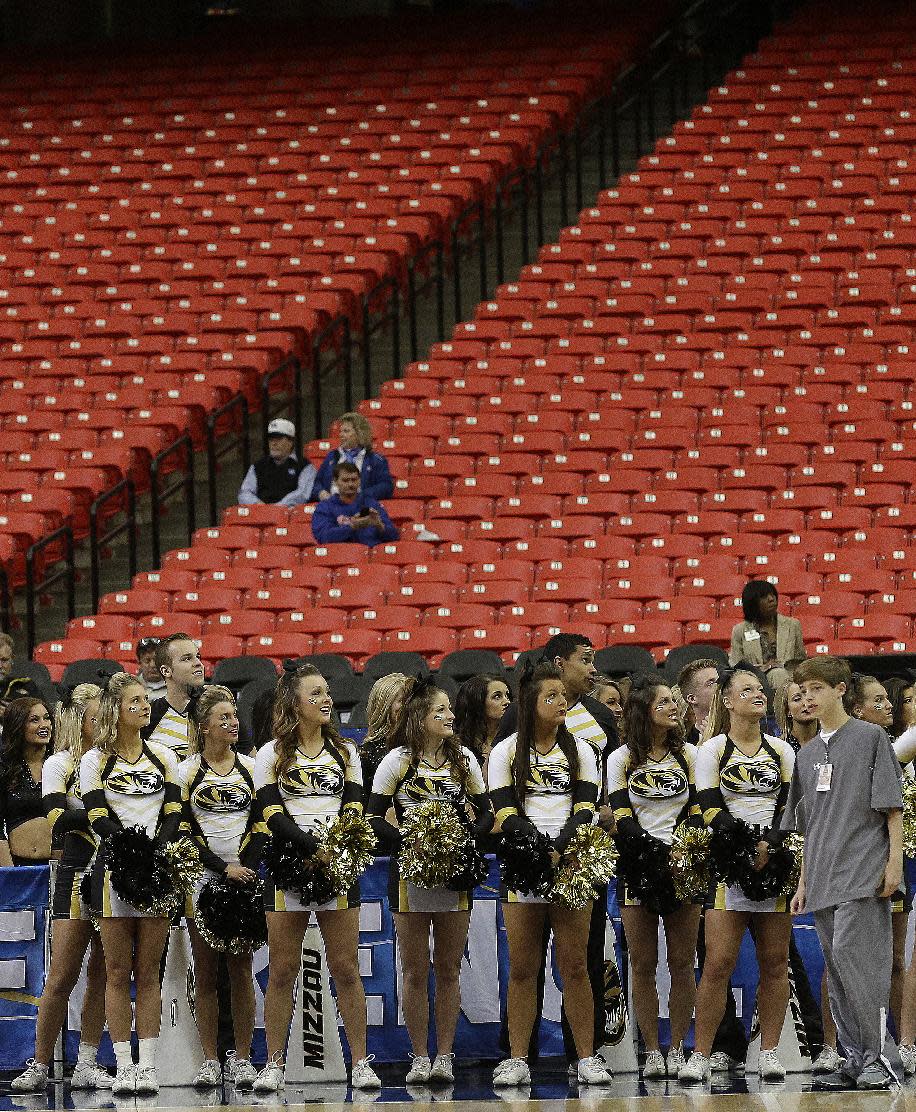 Missouri cheerleaders watch the floor during the first half of an NCAA college basketball game against Florida in the quarterfinal round of the Southeastern Conference men's tournament, Friday, March 14, 2014, in Atlanta. With rivalries in tatters, league alignments all messed up, and tens of thousands of empty seats, it might be time to reassess the need for conference tournaments. (AP Photo/Steve Helber)