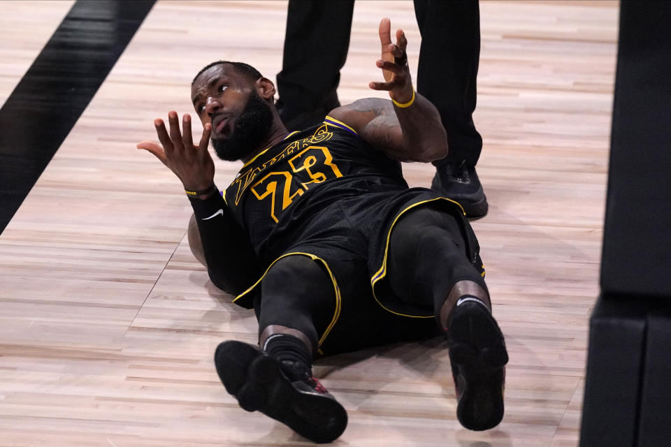 Los Angeles Lakers' LeBron James (23) reacts to a call on the floor during the second half of an NBA conference semifinal playoff basketball game against the Houston Rockets Sunday, Sept. 6, 2020, in Lake Buena Vista, Fla. (AP Photo/Mark J. Terrill)