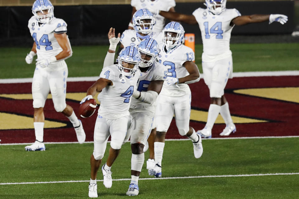 North Carolina defensive back Trey Morrison (4) celebrates after running the ball back on an interception of a two-point conversion attempt by Boston College during the second half of an NCAA college football game, Saturday, Oct. 3, 2020, in Boston. (AP Photo/Michael Dwyer)