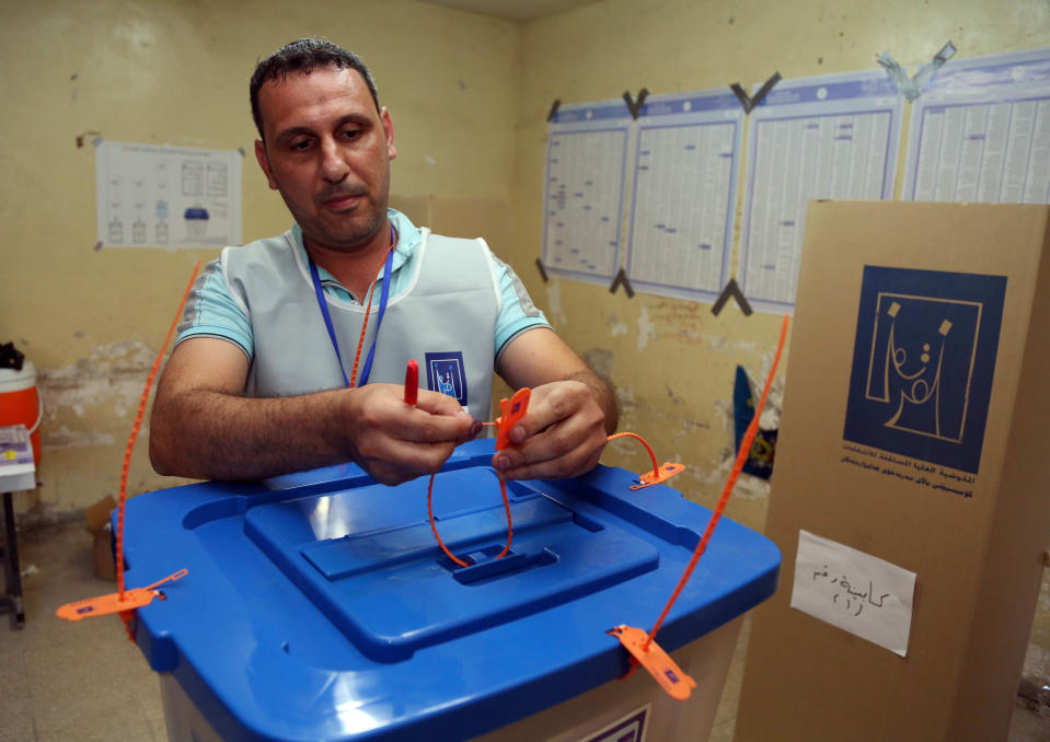 An election worker seals a ballot box as polls close at a polling center in Baghdad, Iraq, Wednesday, April 30, 2014. Iraqis braved the threat of bombs and other violence to vote Wednesday in parliamentary elections amid a massive security operation as the country slides deeper into sectarian strife. (AP Photo/Karim Kadim)