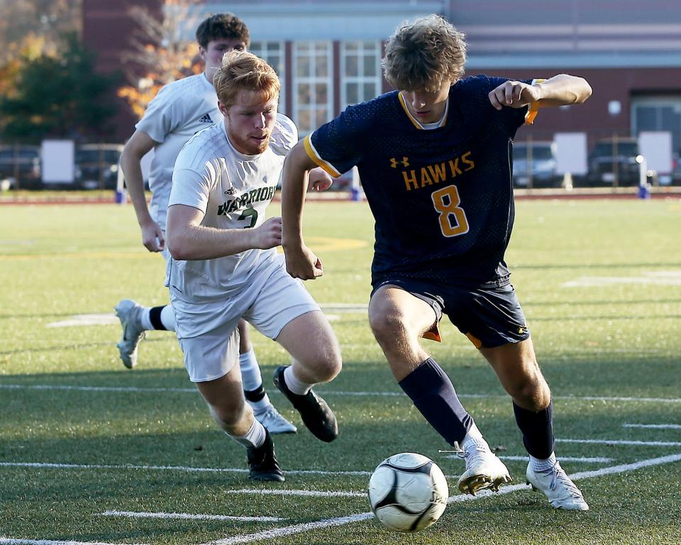 Hanover's Ryan Butzbach goes on the attack along the sidelines while Tantasqua's Paddy McGrath gives chase during second half action of their Round of 32 match against Tantasqua in the Division 3 state tournament at Hanover High on Friday, Nov. 4, 2022. Hanover would go on to win 2-1.