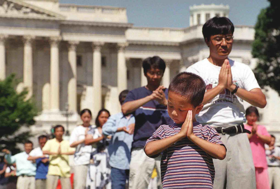 IMage:  Falun Gong followers meditate outside the Capitol in Washington in 1999. (Joyce Naltchayan / AFP via Getty Images file)