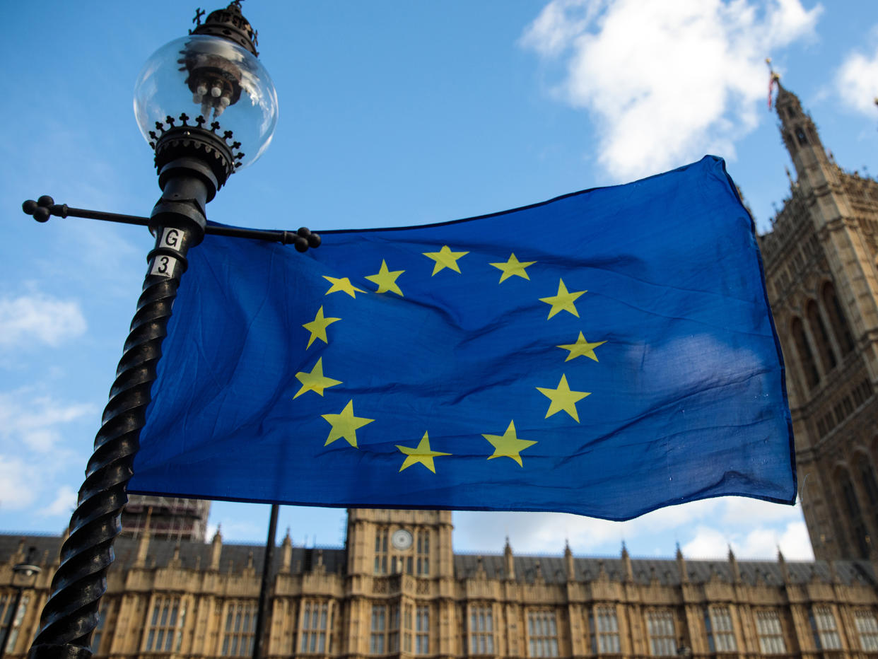 The EU flag flutters from a lamp post outside the Houses of Parliament: Getty