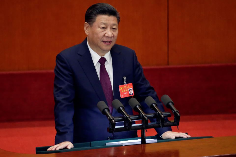 Xi Jinping stands at a podium with microphones.