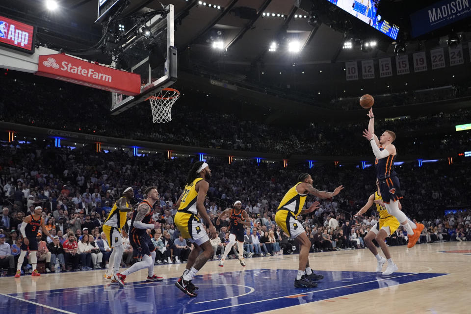 New York Knicks' Donte DiVincenzo, right, shoots over Indiana Pacers' Obi Toppin and Isaiah Jackson (22) during the second half of Game 2 in an NBA basketball second-round playoff series, Wednesday, May 8, 2024, in New York. The Knicks won 130-121. (AP Photo/Frank Franklin II)