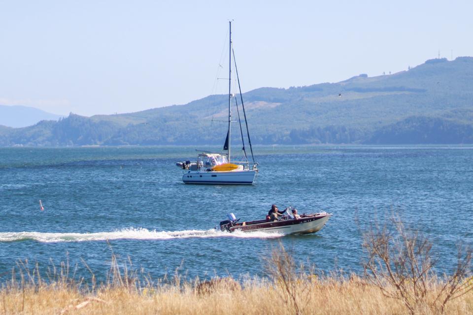 Boats pass through Tillamook Bay July 28, 2023.