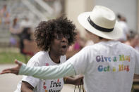 Teresa Parks talks with a friend at the Little Apple Pride festival Saturday, April 23, 2022, in Manhattan, Kan. Inspired by protests following the death of George Floyd, parks co-founded a Black Lives Matter group and as part of a task force has pushed for more inclusion for people from diverse backgrounds in the predominantly white community. (AP Photo/Charlie Riedel)