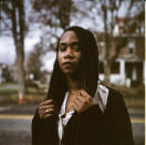 In this photo made with a medium format film camera, Larrecsa Cox, 39, stands for a portrait in Huntington, W.Va., Thursday, March 18, 2021. Cox, a paramedic, leads the Quick Response Team that within days visits everyone who overdoses to try to pull them back from the brink. "You're not in trouble," she says, gives them the overdose reversal medication naloxone and offers help navigating their way to recovery. Huntington was once ground-zero for this epidemic. It was a hard-fought battle, but it worked. The county's overdose rate plummeted. They wrestled down an HIV crisis. Then the pandemic arrived undid much of their effort. "I can't believe we've lost all these people," said Cox. "But sometimes, you just have to focus on the living." (AP Photo/David Goldman)