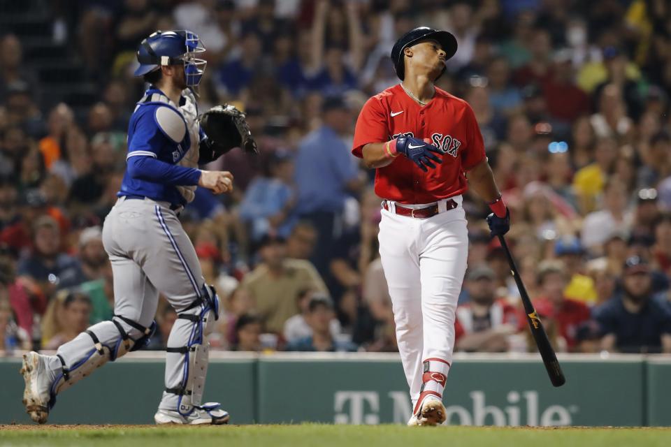 Boston Red Sox's Jeter Downs reacts after being called out on strikes to end the fourth inning as Toronto Blue Jays' Danny Jansen, left, heads to the dugout during a baseball game Friday, July 22, 2022, in Boston. (AP Photo/Michael Dwyer)