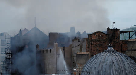 Firefighters attend to a blaze at the Mackintosh Building at the Glasgow School of Art, which is the second time in four years, Glasgow, Scotland, Britain June 16, 2018. REUTERS/Russell Cheyne?