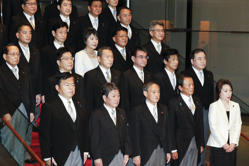 Japan's new Prime Minister Yoshihide Suga, center in front row, poses for a group photo with his cabinet members following the first Cabinet meeting at the prime minister's official residence in Tokyo Wednesday, Sept. 16, 2020. Japan's Parliament elected Yoshihide Suga as prime minister Wednesday, replacing long-serving leader Shinzo Abe with his right-hand man.(Rodrigo Reyes Marin/Pool Photo via AP)