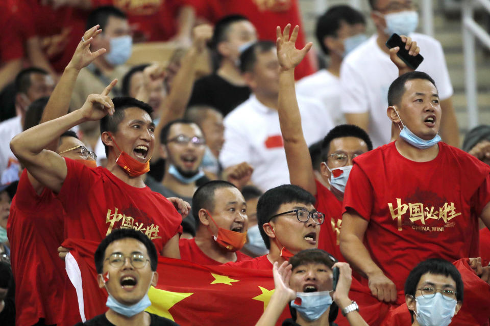 FILE - Chinese soccer fans shout after their national team lost from Saudi Arabia during their match of the Asian zone group B qualifying soccer match for the FIFA World Cup Qatar 2022 at the King Abdullah sports city stadium, in Jiddah, Saudi Arabia, on Oct. 12, 2021. After three years of isolation and financial struggles in Chinese soccer the country is reopening its borders and economy to the outside world. With it, frustrated fans, financially-challenged clubs and unpaid players in the Chinese Super League might receive some long-awaited good news.(AP Photo/Amr Nabil, File)