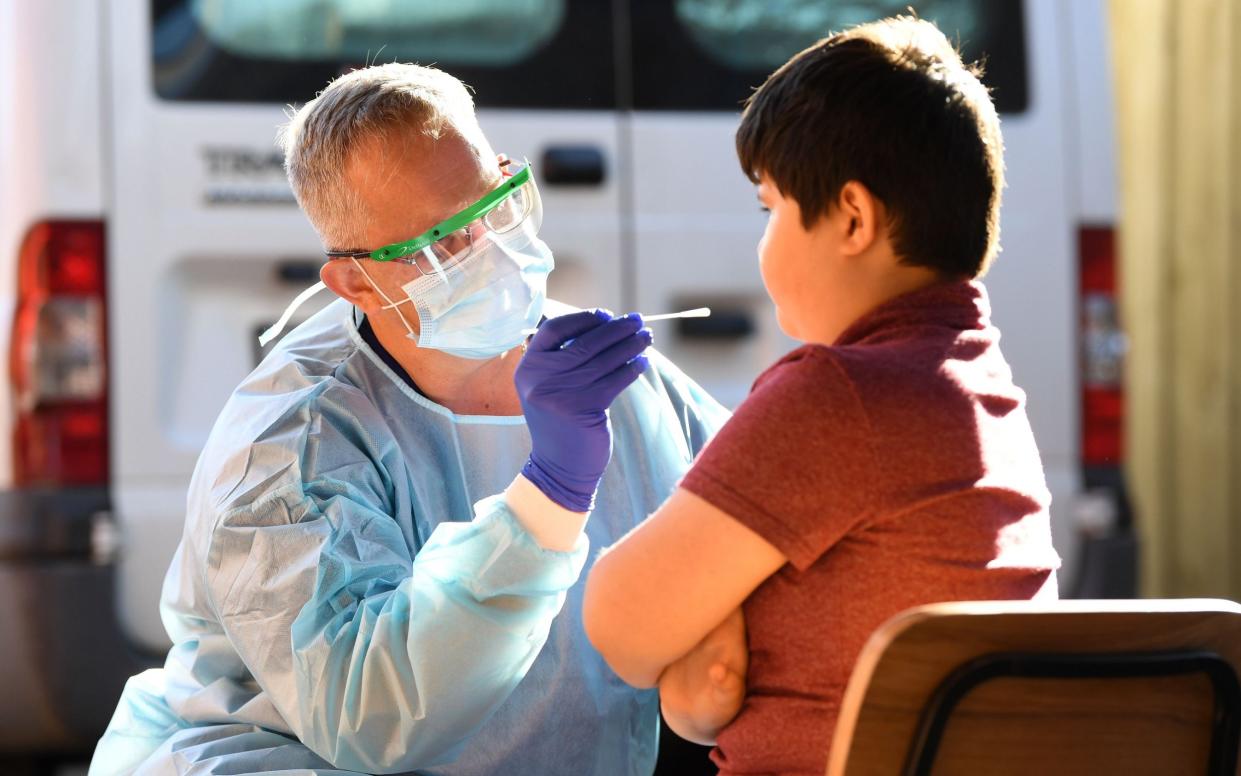 A nurse swabs a child in Melbourne - JAMES ROSS/EPA-EFE/Shutterstock