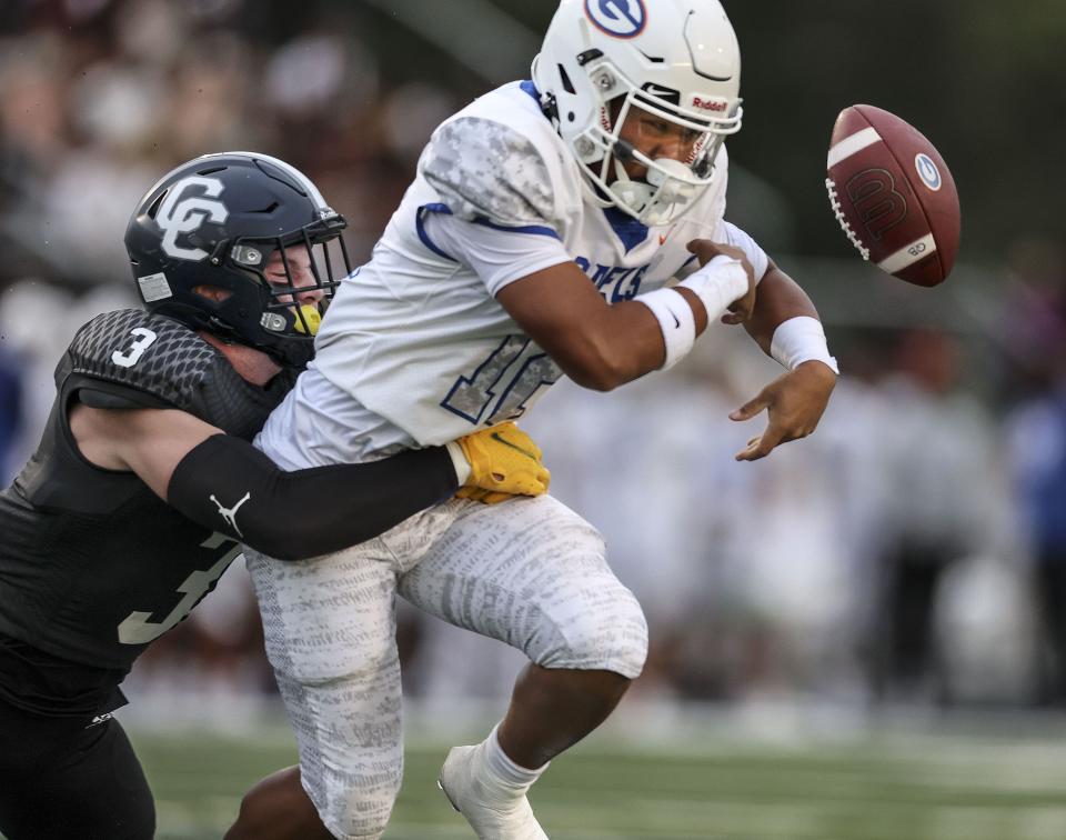 Corner Canyon’s Bo Tate causes Bishop Gorman’s QB Micah Alejado to fumble during a nonleague football game at Corner Canyon High school in Draper on Friday, Aug. 18, 2023. | Laura Seitz, Deseret News