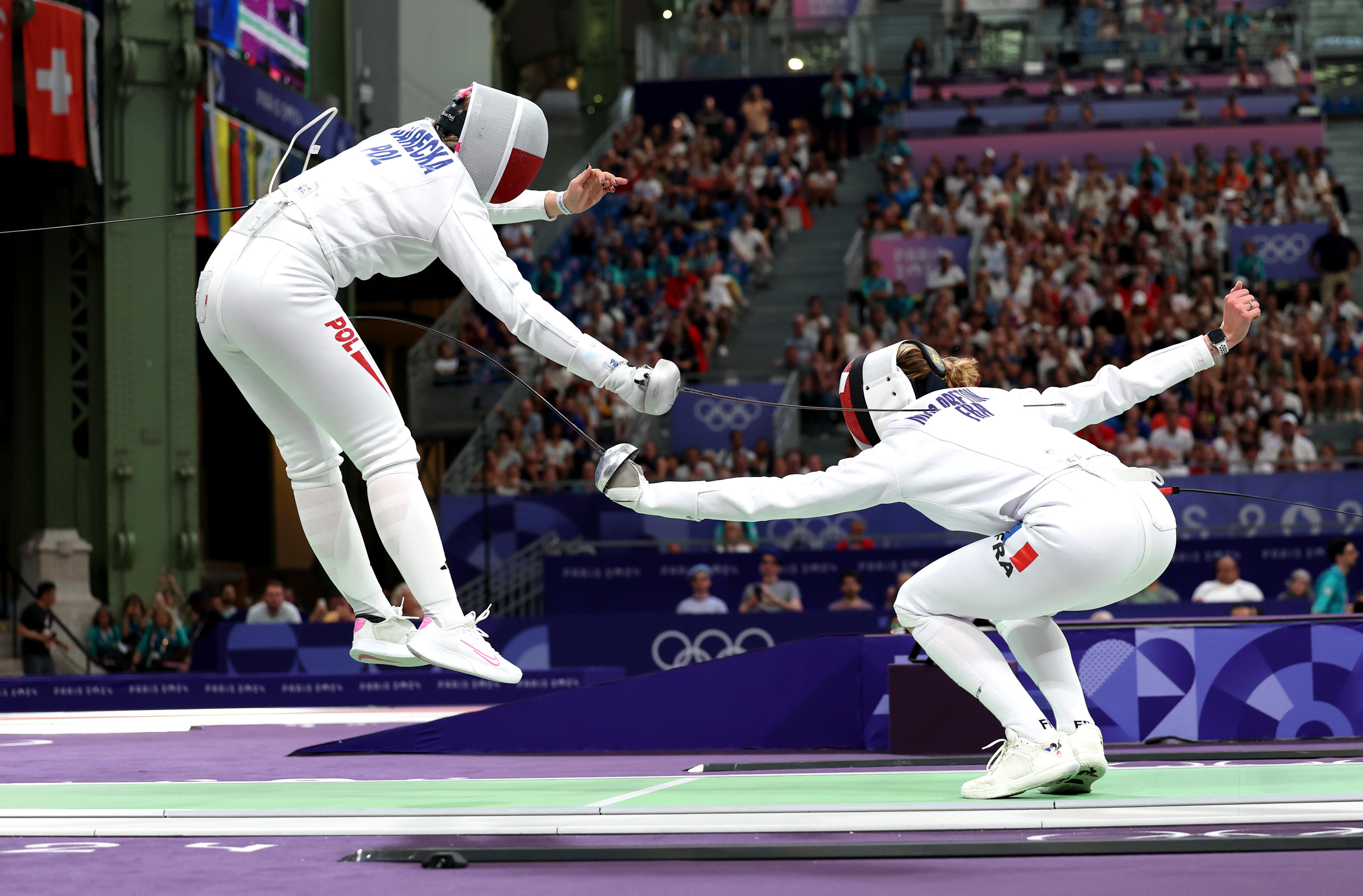 Aleksandra Jarecka of Poland (left) and Auriane Mallo-Breton of France compete during the women's epee team semifinal. (Photo by Elsa/Getty Images)