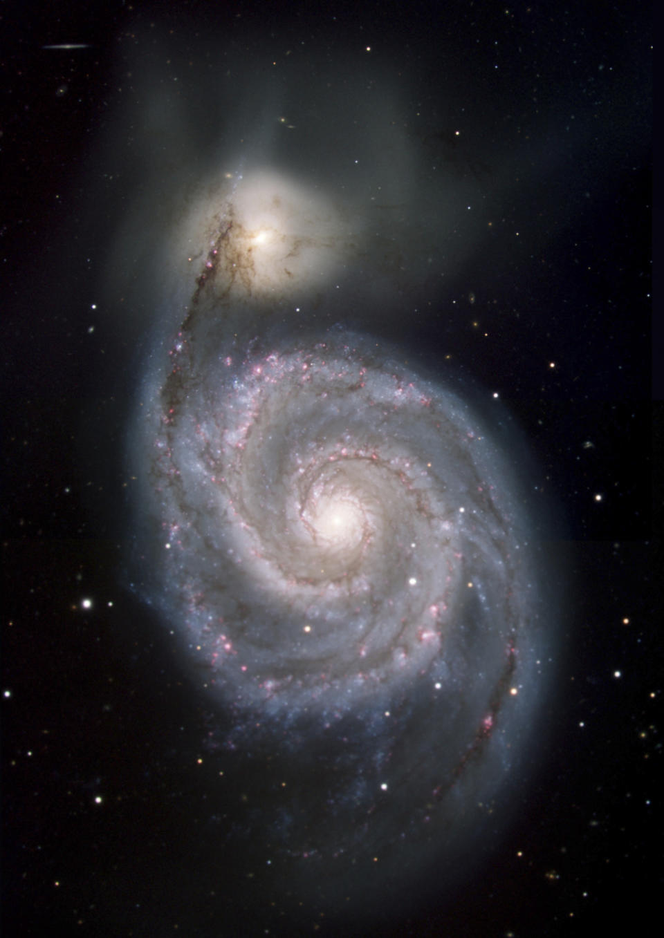 This image made available by NASA shows the Whirlpool galaxy, which is actually a pair of galaxies Messier 51 and NGC 5194/5195, approximately 23 million light-years away from Earth. This image shows a view in visible light, from the Kitt Peak National Observatory telescope as part of the Spitzer Infrared Nearby Galaxies Survey (SINGS) project. (NASA/JPL-Caltech via AP)