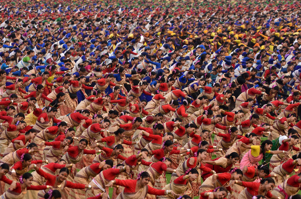 Participants wearing colourful attire perform Bihu dance, a traditional folk dance, to try and set a Guinness World Record for the largest Bihu dance performance in the world at a single venue, in Guwahati, India, April 13, 2023. REUTERS/Anuwar Hazari