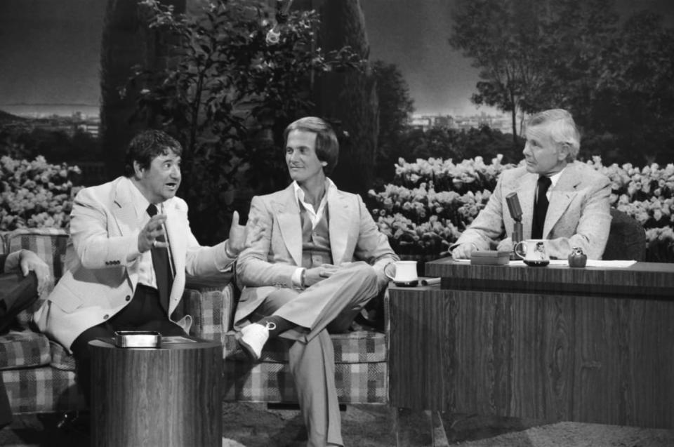 <div class="inline-image__caption"><p>Boone with comedian Buddy Hackett on the Tonight Show in 1978.</p></div> <div class="inline-image__credit">NBC via Getty</div>